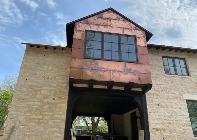 Copper metal panel facade on a stone building for Skylight Installation in Kearney