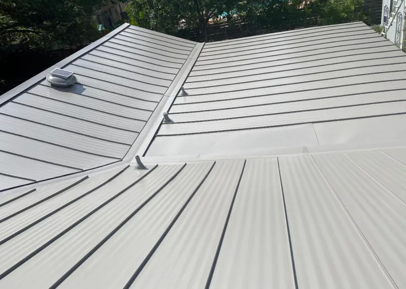 Solar attic fan installed on a metal roof for Roof Ventilation in Kearney